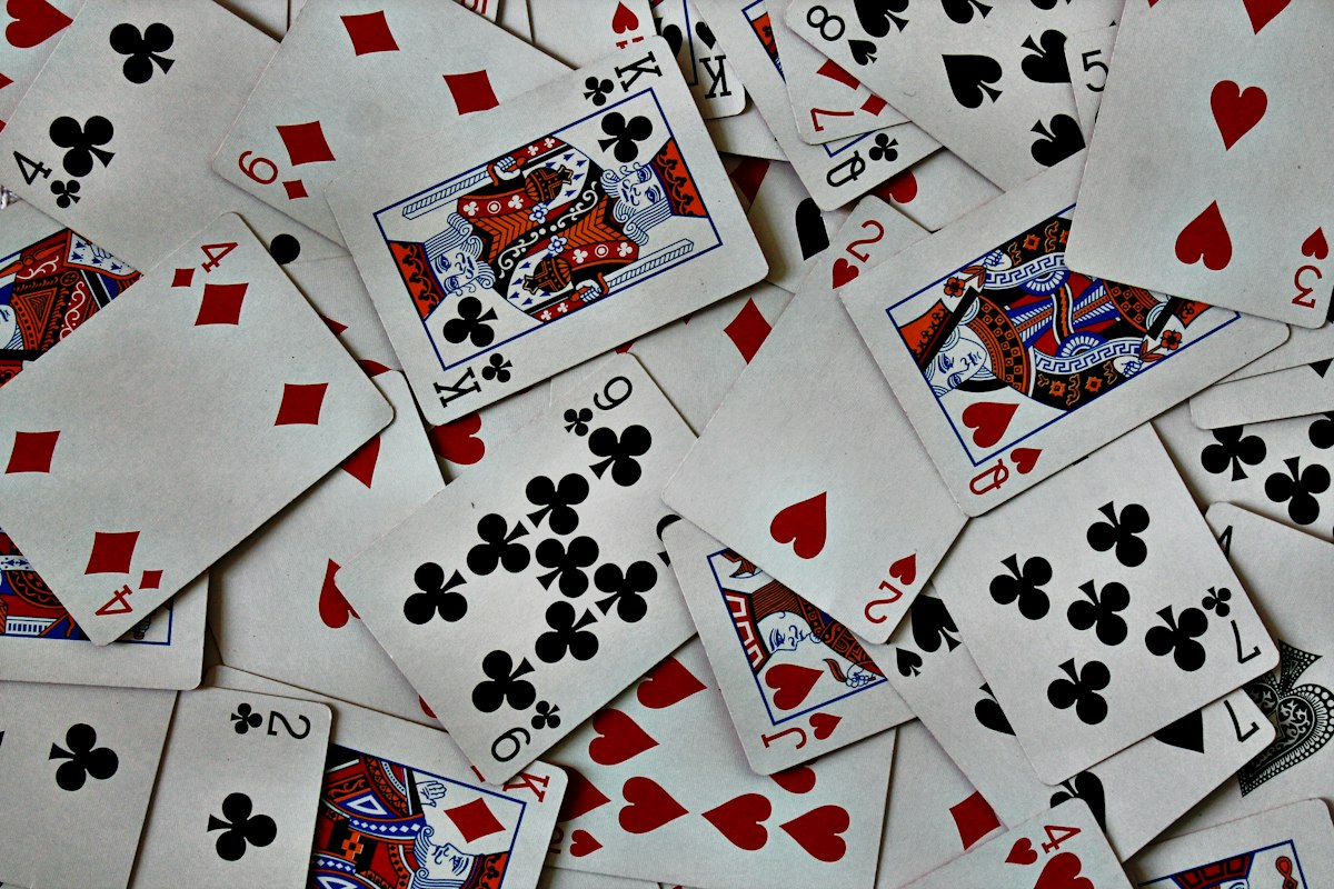 A scattered pile of playing cards on a table
