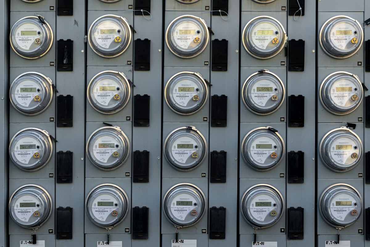Rows of electricity meters mounted on a wall